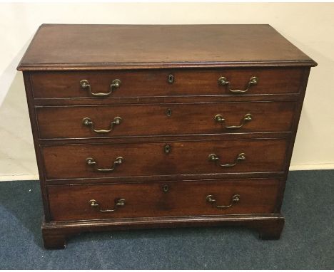 A Georgian mahogany four drawer chest on bracket feet with brass handles. Est. £100 - £200.