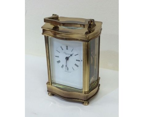 A brass mounted carriage clock. Est. £30 - £50.