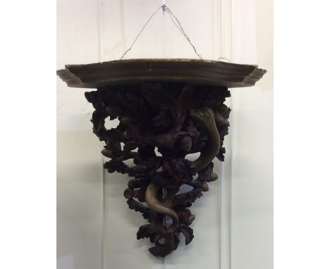 An attractive gilt wooden bracket decorated with serpents and acorns. Est. £100 - £150.