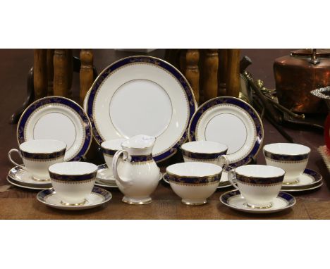A Royal Grafton six place bone china tea service decorated with Royal blue border and gilt decoration.