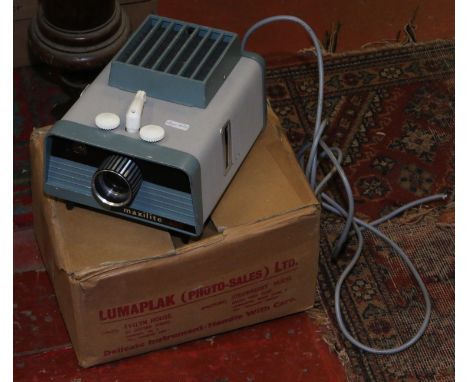 A Lumaplak Maxilite 300 projector with case and box.