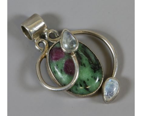 A silver pendant set with ruby ziosite and moonstone.