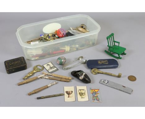 A box of collectables including lace bobbins, advertising tin, brass cat formed door knocker etc.