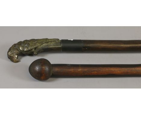 A sword stick with cast brass handle formed as a perched parrot along with a turned African hardwood knob kerry throwing club