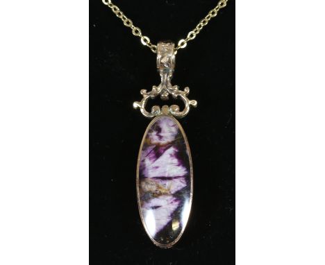 A 9ct gold blue john and mother of pearl pendant on yellow metal chain.