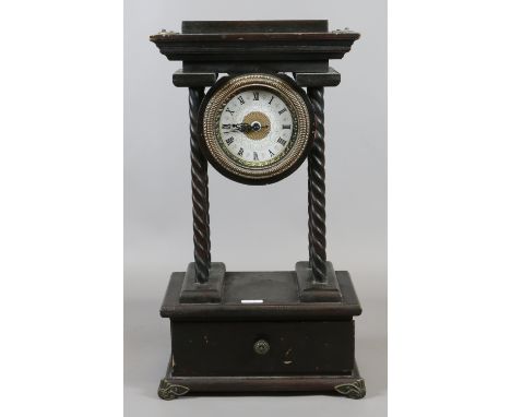 A Quartz movement mantel clock raised on barleytwist columns over a single drawer.