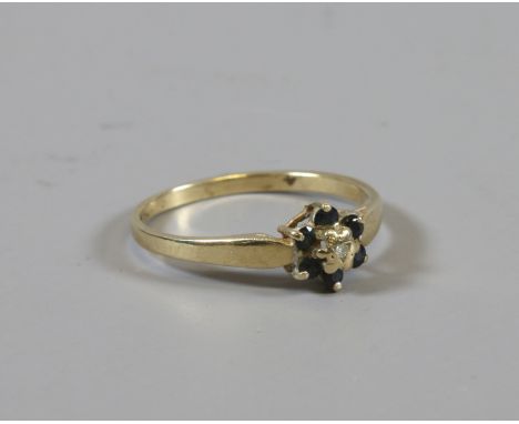 A 9ct gold diamond and sapphire cluster ring, size K.