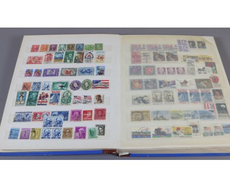 A school boy stamp collection held in an album containing mostly British and Commonwealth coins.