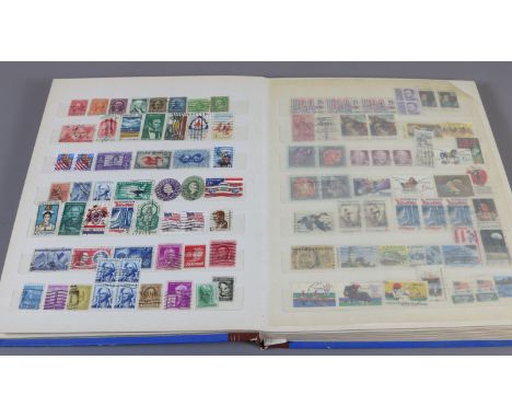 A school boy stamp collection held in an album containing mostly British and Commonwealth coins.