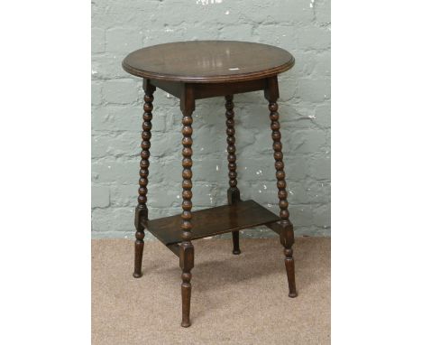 A C20th oak side table with rectangular lower tier raised on turned and bobbin supports.