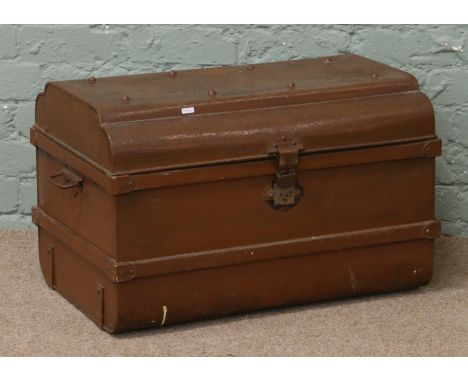 A painted steel dome top travel trunk with twin handles.