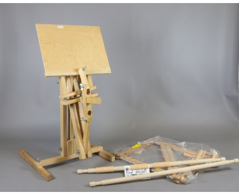 A wooden tapestry frame and adjustable folding easel.