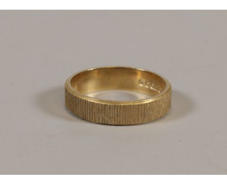 A 9ct gold textured wedding band, 3.2 grams size O.