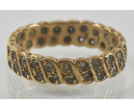 A 9ct gold eternity ring, with two rows of repeating tiny diamond chips, size V, approx 4.9g.