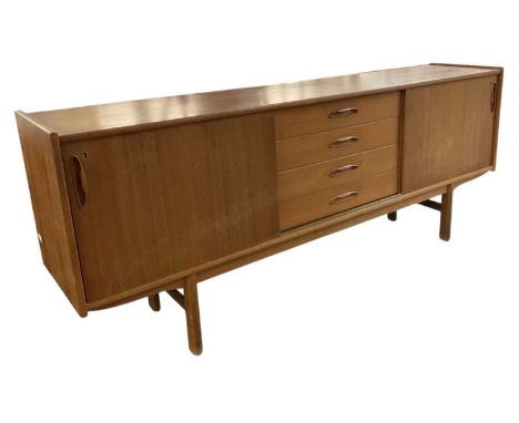 A teak mid century sideboard, with pair of cupboard doors flanked by four long drawers, width 200cm.