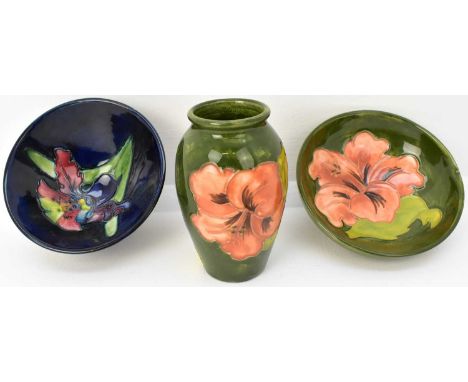 MOORCROFT; three small cabinet items comprising a 'Hibiscus' pattern green ground baluster vase, height 10cm, a conical bowl,