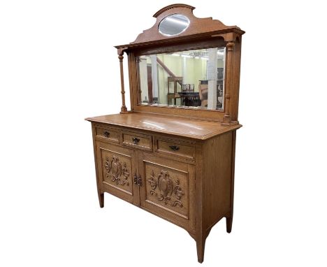 An early 20th century light oak mirror back sideboard, with three drawers above pair of cupboard doors, width 137cm.