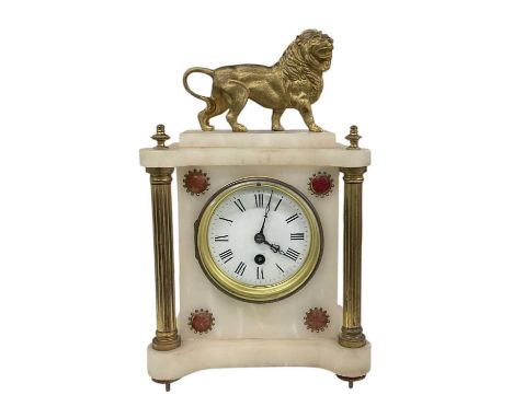 A late 19th/early 20th century French white marble and gilt metal mounted mantel clock surmounted with lion decoration, the w