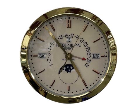 A decorative Patek Philippe style dealer's wall clock, the cream dial set with subsidiary seconds, hour markers, day and date