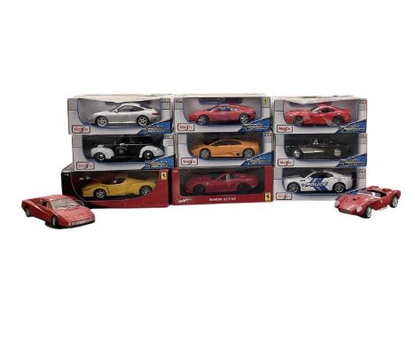 A collection of nine large boxed model vehicles including Hot Wheels Ferrari 599 GTO, Maisto Chevrolet Camaro, Chevrolet Corv