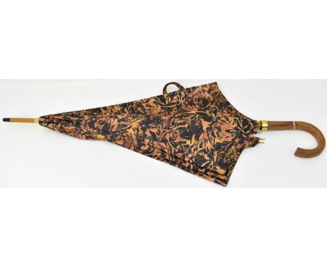 A vintage Valentino umbrella with black and orange pattern.