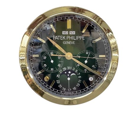 A decorative Patek Philippe style dealer's wall clock, the green dial set with subsidiary seconds, gold hour markers, day and