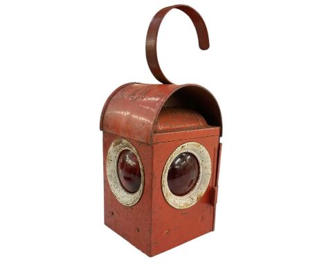 An early 20th century red painted hanging railway lamp, with original burner and three red glass panels, height to top of han