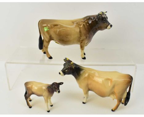 BESWICK; a family of three Jersey cows comprising bull, cow and calf (3).Condition Report: The cow has had a repair to the fr