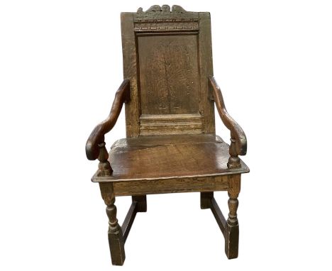 A 17th century oak wainscot type chair, with carved back inscribed 'F.C.1.6.C'. 