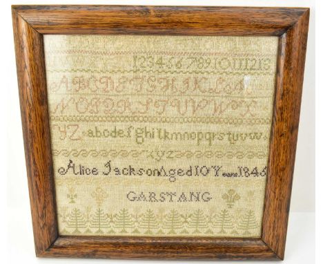 A mid Victorian sampler featuring the alphabet and various trees, by Alice Jackson, aged 10 years, 1846, Garstang, in oak gla