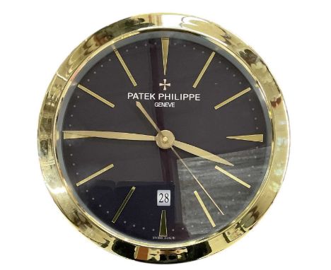 A decorative Patek Philippe style dealer's wall clock, the black dial set with subsidiary seconds, gold hour markers and date