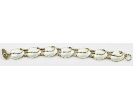 VOLMER BAHNER (VB); a Scandinavian silver bracelet, with seven white enamelled shell links, marked 'Sterling, Denmark' to the