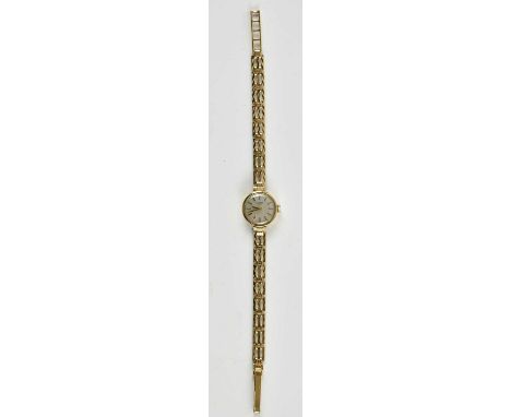 ROTARY; a lady's 9ct gold wristwatch, the silvered dial set with raised baton markers, with crown wind movement, on a 9ct gol