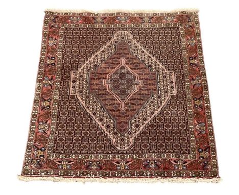 A modern machine made red ground Persian style carpet, with floral designed border, 156 x 121cm.