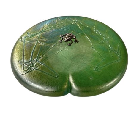 † JOHN DITCHFIELD FOR GLASFORM; a round glass iridescent green lily pad paperweight, with hallmarked silver frog to top, sign