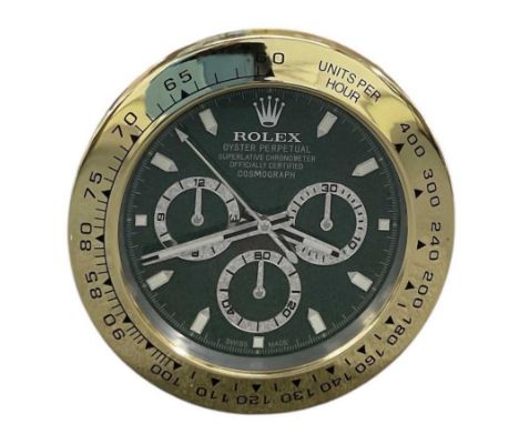 A decorative Rolex Daytona Cosmograph style dealer's wall clock, the green dial set with subsidiary seconds, with gold bezel,