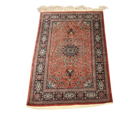 An Isfahan red ground silk rug, with geometric designs, 165 x 103cm.