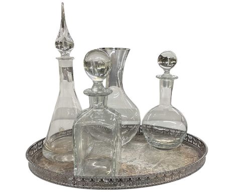 DARTINGTON CRYSTAL; a lead crystal decanter, height 37.5cm, two further decanters and a wine vessel, height 27cm, on an oval 