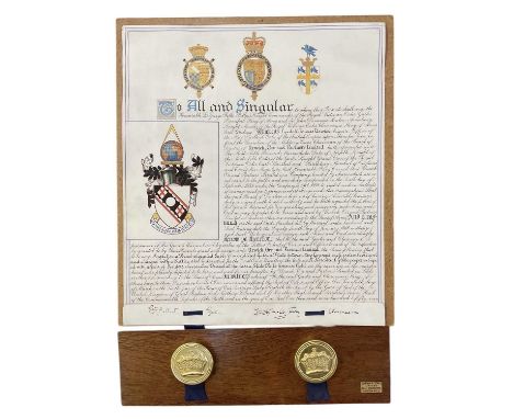 A coat of arms indenture, mounted on a Jordan &amp; Sons Ltd board set with two Royal seals, 62 x 45cm.