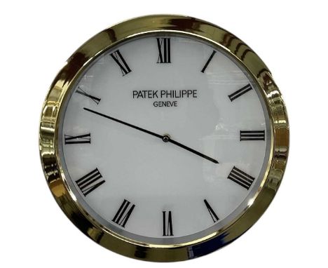 A decorative Patek Philippe style dealer's wall clock, the white dial set with Roman numerals and inscribed 'Patek Philippe G