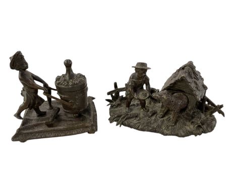 A late 19th/early 20th century Continental bronze figural inkwell of a young boy pulling a churn, height 11.5cm, width 11.5cm