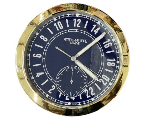 A decorative Patek Philippe style dealer's wall clock, the blue dial set with subsidiary seconds and twenty-four hour Arabic 