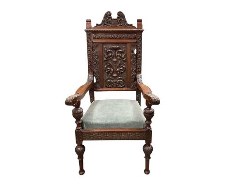 A 19th century heavily carved walnut armchair, with swan neck scroll with shield, later added date '1904' above pie crust rim