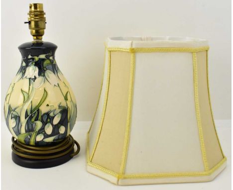 MOORCROFT; a 'Nivalis Snowdrops' pattern table lamp, with wooden circular base and original shade, height to bulb holder 29cm