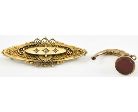 A Victorian 15ct gold brooch of oval shape, set with three diamonds, with steel pin, length 5cm, approx 5.7g, and a 9ct gold 