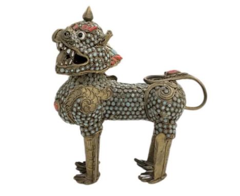 A Tibetan brass and jewelled scent bottle modelled as a temple dog, set with small turquoise and coral beads, with detachable