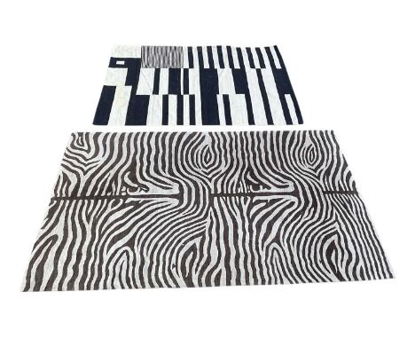 RALO CARPET; a modern machine made grey and brown zebra print carpet, 275 x 185cm, and a black and white Turkish Kilim carpet