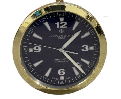 A decorative Vacheron Constantin Automatic Anti-Magnetic style dealer's wall clock, the blue dial set with Arabic numerals, h