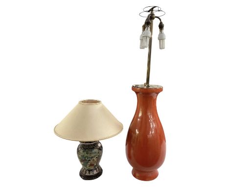 A modern large red glazed baluster form porcelain table lamp, with brass fitments and three branches, height to top of fitmen