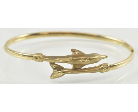 A 9ct gold dolphin bracelet, internal diameter 6cm, approx 4g.Condition Report: This bangle is not magnetic.